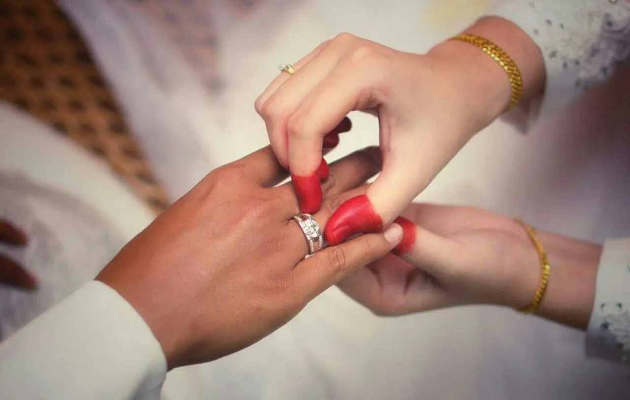 Close-up of hands during a wedding ring exchange